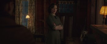 Movie still from “The Finest Hours” (2016), directed by Craig Gillespie – A woman standing in a room with her arms crossed; Medium shot, Over the shoulder angle