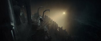 Movie still from “The Finest Hours” (2016), directed by Craig Gillespie – A group of people standing in a dark room; Extreme Wide shot, High angle