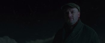 Movie still from “The Finest Hours” (2016), directed by Craig Gillespie – A man wearing a hat and a jacket in the dark; Close Up shot, Low angle