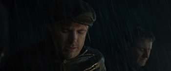 Movie still from “The Finest Hours” (2016), directed by Craig Gillespie – A person wearing a hat in the rain; Close Up shot, Low angle