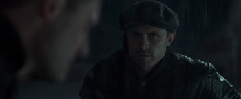 Movie still from “The Finest Hours” (2016), directed by Craig Gillespie – A person wearing a hat and jacket; Close Up shot, Over the shoulder angle