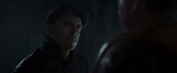 Movie still from “The Finest Hours” (2016), directed by Craig Gillespie – A man wearing a hat looking at another man in the rain; Close Up shot, Over the shoulder angle