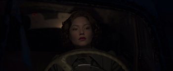Movie still from “The Finest Hours” (2016), directed by Craig Gillespie – A woman sitting in the driver's seat of a car; Close Up shot, High angle