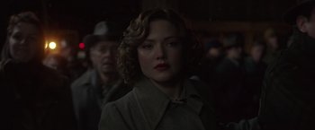 Movie still from “The Finest Hours” (2016), directed by Craig Gillespie – A person wearing a coat and hat; Close Up shot, Over the shoulder angle
