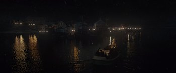 Movie still from “The Finest Hours” (2016), directed by Craig Gillespie – A group of people in a boat at night on a body of water; Extreme Wide shot, High angle