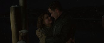 Movie still from “The Finest Hours” (2016), directed by Craig Gillespie – A man and a woman hugging in the dark; Medium shot, Low angle
