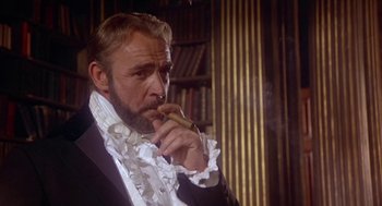 Movie still from “The Great Train Robbery” (1978), directed by Michael Crichton – A man smoking a cigar while wearing a suit and tie; Close Up shot, Low angle