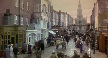 Movie still from “The Great Train Robbery” (1978), directed by Michael Crichton – An old photo of people walking down the street; Extreme Wide shot, High angle