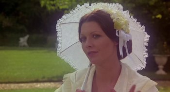 Movie still from “The Great Train Robbery” (1978), directed by Michael Crichton – A woman in a white dress holding an umbrella; Close Up shot, High angle