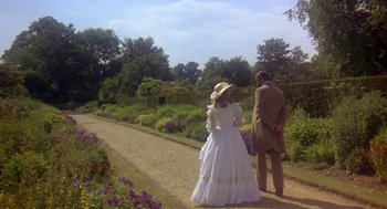 Movie still from “The Great Train Robbery” (1978), directed by Michael Crichton – A man and a woman dressed in period clothing stand on the side of a dirt road; Wide shot, High angle
