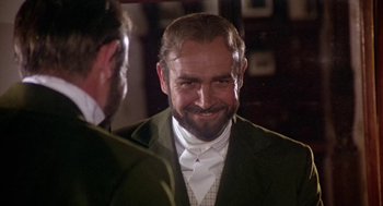 Movie still from “The Great Train Robbery” (1978), directed by Michael Crichton – A person wearing a suit and tie; Close Up shot, Over the shoulder angle