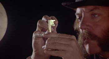 Movie still from “The Great Train Robbery” (1978), directed by Michael Crichton – A man holding a key in his hands; Extreme Close Up shot, High angle