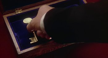 Movie still from “The Great Train Robbery” (1978), directed by Michael Crichton – A hand is holding a key to a key hole; Extreme Close Up shot, High angle