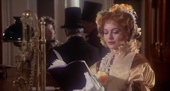 Movie still from “The Great Train Robbery” (1978), directed by Michael Crichton – A woman in a victorian era dress reading a book; Close Up shot, Over the shoulder angle