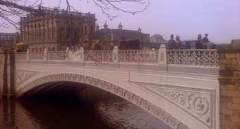 Movie still from “The Great Train Robbery” (1978), directed by Michael Crichton – A group of people standing on a bridge over a river; Extreme Wide shot, High angle