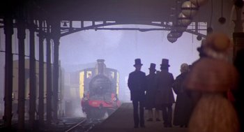 Movie still from “The Great Train Robbery” (1978), directed by Michael Crichton – A group of people standing on a train platform; Wide shot, Low angle