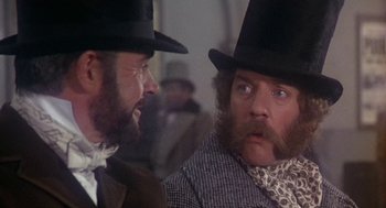 Movie still from “The Great Train Robbery” (1978), directed by Michael Crichton – Two men wearing hats and one has a beard; Close Up shot, Over the shoulder angle