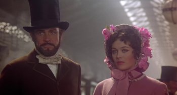 Movie still from “The Great Train Robbery” (1978), directed by Michael Crichton – A man and a woman dressed in period clothing; Medium shot, Low angle