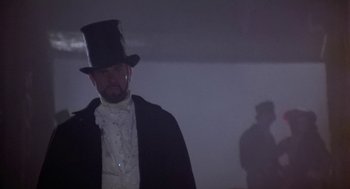 Movie still from “The Great Train Robbery” (1978), directed by Michael Crichton – A man wearing a top hat and a long coat; Medium shot, Low angle