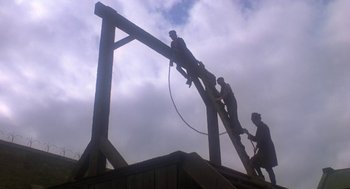 Movie still from “The Great Train Robbery” (1978), directed by Michael Crichton – A group of men standing on top of a wooden structure; Extreme Wide shot, Low angle