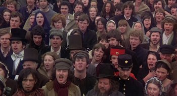 Movie still from “The Great Train Robbery” (1978), directed by Michael Crichton – A large group of people wearing hats and coats; Close Up shot, High angle