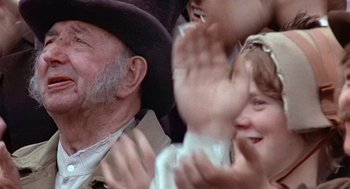 Movie still from “The Great Train Robbery” (1978), directed by Michael Crichton – An old man and two young children waving hands; Close Up shot, Over the shoulder angle