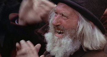 Movie still from “The Great Train Robbery” (1978), directed by Michael Crichton – An old man with long white hair and a long beard; Close Up shot, Over the shoulder angle