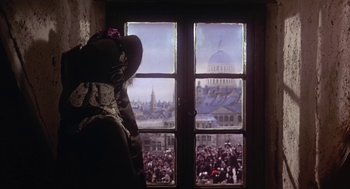 Movie still from “The Great Train Robbery” (1978), directed by Michael Crichton – A view of a crowd of people gathered in front of a window; Medium shot, Low angle