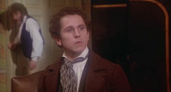 Movie still from “The Great Train Robbery” (1978), directed by Michael Crichton – A man with curly hair wearing a suit and tie; Close Up shot, Over the shoulder angle