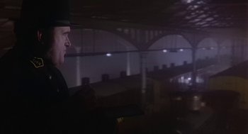 Movie still from “The Great Train Robbery” (1978), directed by Michael Crichton – A man wearing a top hat is looking out of a window; Medium shot, Low angle
