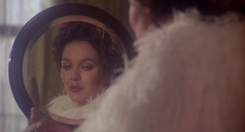 Movie still from “The Great Train Robbery” (1978), directed by Michael Crichton – A woman looking in the mirror in front of a mirror; Close Up shot, Over the shoulder angle