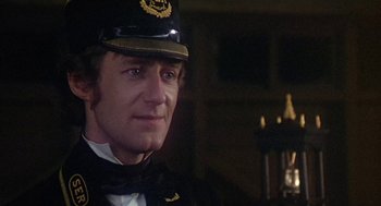 Movie still from “The Great Train Robbery” (1978), directed by Michael Crichton – A person wearing a uniform; Close Up shot, Over the shoulder angle