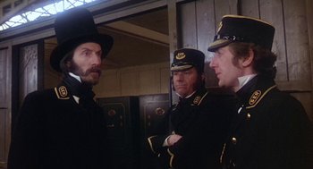 Movie still from “The Great Train Robbery” (1978), directed by Michael Crichton – A group of men standing next to each other in uniforms; Medium shot, Low angle