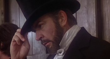 Movie still from “The Great Train Robbery” (1978), directed by Michael Crichton – A man with a beard wearing a black hat; Close Up shot, Low angle
