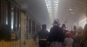 Movie still from “The Great Train Robbery” (1978), directed by Michael Crichton – A group of people walking down a train platform; Wide shot, Low angle