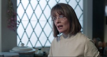 Movie still from “The First Wives Club” (1996), directed by Hugh Wilson – A woman wearing glasses and a white shirt; Close Up shot, Over the shoulder angle