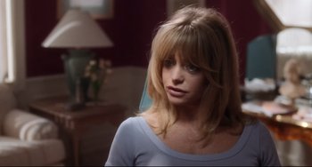 Movie still from “The First Wives Club” (1996), directed by Hugh Wilson – A woman in a blue shirt is looking to her left; Close Up shot, Over the shoulder angle