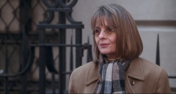 Movie still from “The First Wives Club” (1996), directed by Hugh Wilson – A person wearing glasses and a scarf; Close Up shot, Over the shoulder angle