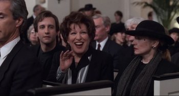 Movie still from “The First Wives Club” (1996), directed by Hugh Wilson – A group of people sitting in front of a computer screen; Medium shot, Over the shoulder angle