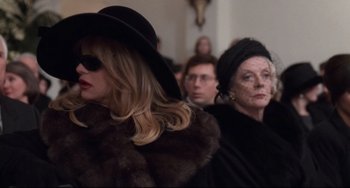 Movie still from “The First Wives Club” (1996), directed by Hugh Wilson – A woman in a black hat and a woman in a fur coat; Close Up shot, Over the shoulder angle