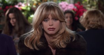 Movie still from “The First Wives Club” (1996), directed by Hugh Wilson – A person with long blonde hair; Close Up shot, High angle
