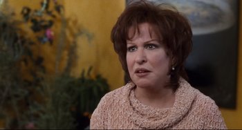 Movie still from “The First Wives Club” (1996), directed by Hugh Wilson – A person wearing a sweater and looking sad; Close Up shot, Over the shoulder angle