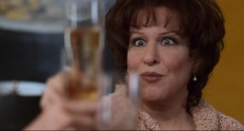 Movie still from “The First Wives Club” (1996), directed by Hugh Wilson – A person holding a glass of beer; Close Up shot, Over the shoulder angle