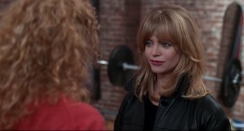 Movie still from “The First Wives Club” (1996), directed by Hugh Wilson – A woman in a black jacket talking to another woman; Close Up shot, Over the shoulder angle
