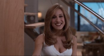 Movie still from “The First Wives Club” (1996), directed by Hugh Wilson – A woman with long blonde hair smiling for the camera; Close Up shot, High angle