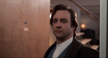 Movie still from “The First Wives Club” (1996), directed by Hugh Wilson – A person wearing a suit and tie; Close Up shot, Low angle