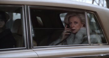 Movie still from “The First Wives Club” (1996), directed by Hugh Wilson – An older woman talking on a phone in a car; Medium shot, Low angle