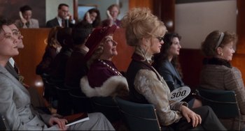 Movie still from “The First Wives Club” (1996), directed by Hugh Wilson – A group of people sitting in chairs in a room; Medium shot, Over the shoulder angle