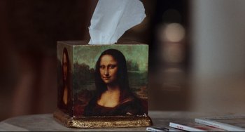 Movie still from “The First Wives Club” (1996), directed by Hugh Wilson – A tissue box with a picture of a woman on it; Extreme Close Up shot, High angle