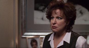 Movie still from “The First Wives Club” (1996), directed by Hugh Wilson – A person wearing a suit and tie; Close Up shot, Over the shoulder angle